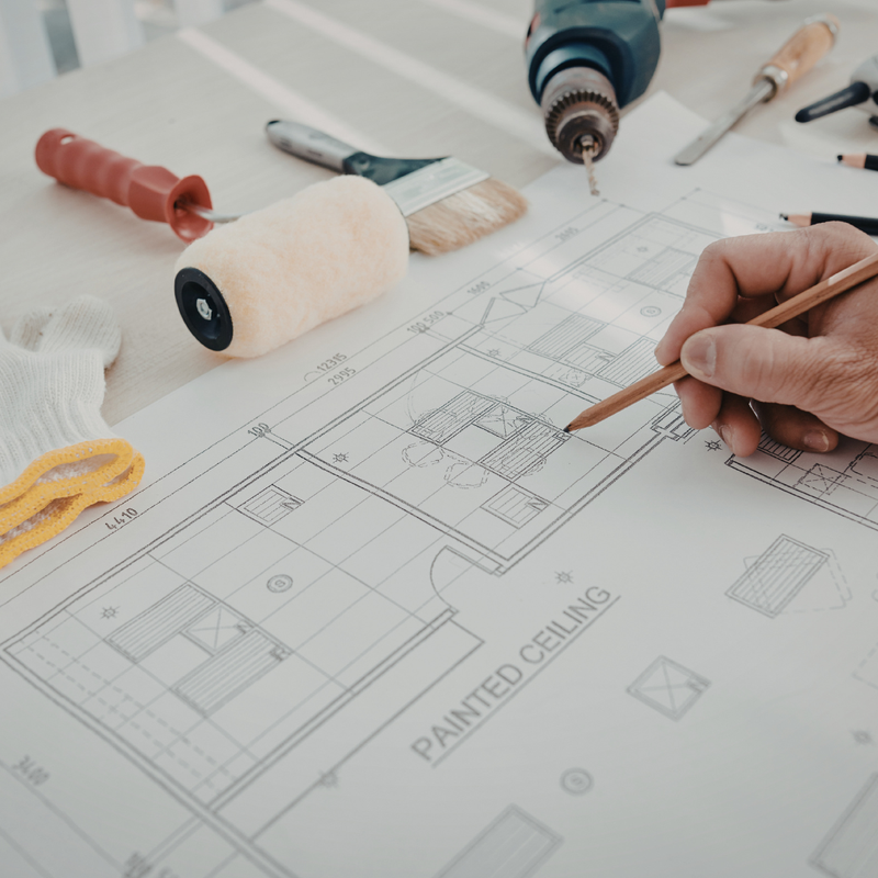 Ontario homeowner reviewing renovation plans and blueprints with contractor — spring renovation planning guide